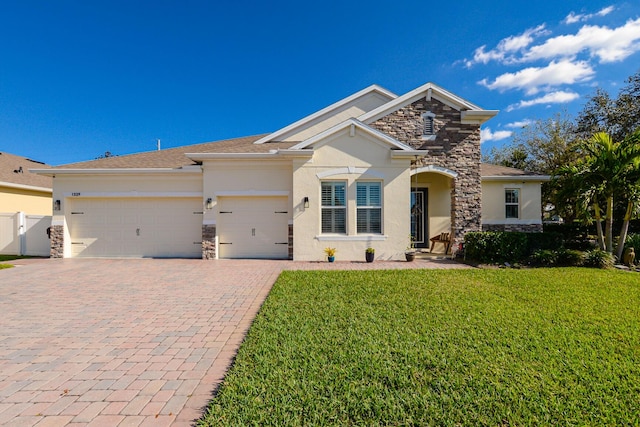 view of front of home with a front lawn and a garage