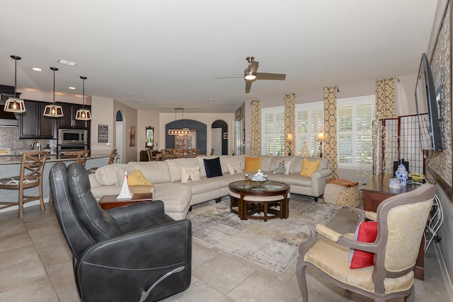 tiled living room with ceiling fan