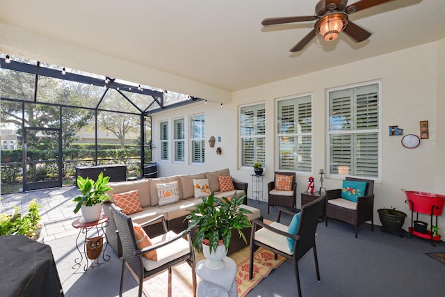 view of patio featuring an outdoor living space, ceiling fan, and a lanai