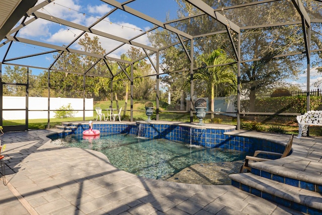 view of swimming pool with pool water feature, glass enclosure, and a patio area