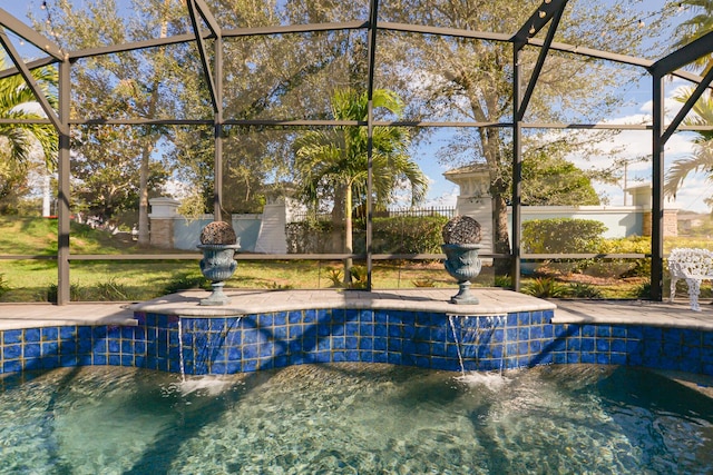 view of swimming pool featuring a lanai and pool water feature