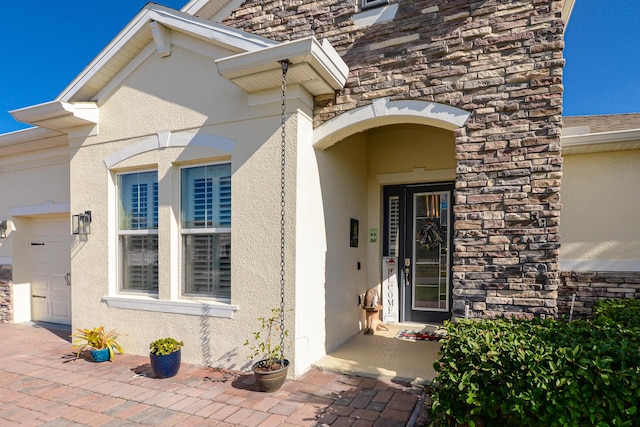 doorway to property featuring a garage