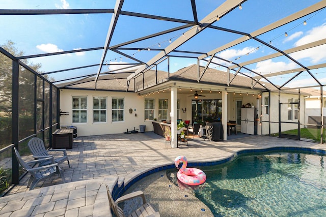 view of swimming pool featuring a lanai, ceiling fan, and a patio