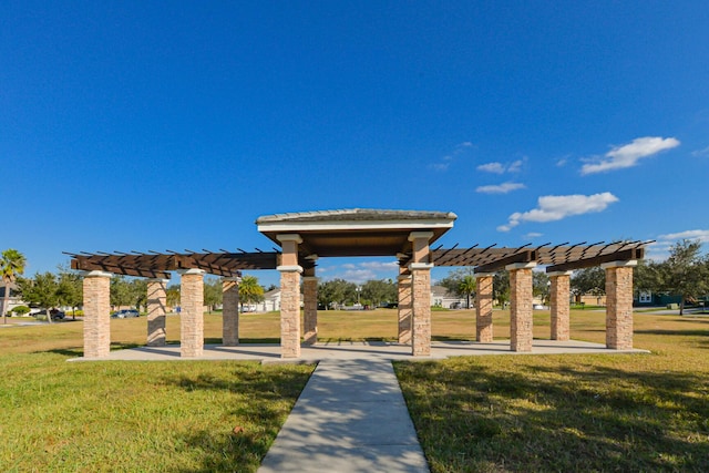 view of community with a yard and a pergola