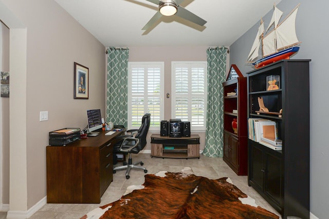 tiled office featuring ceiling fan