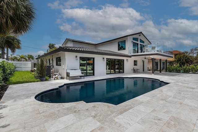 view of pool with ceiling fan and a patio