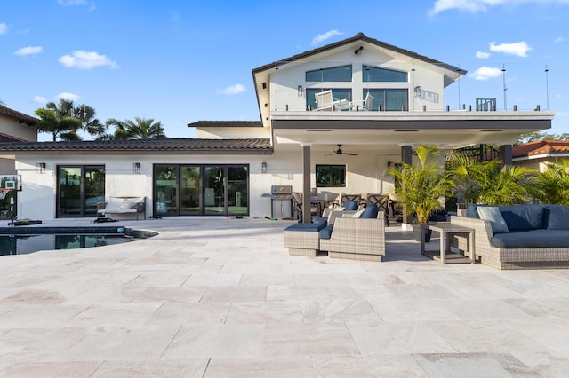 back of property with a patio area, outdoor lounge area, and a balcony