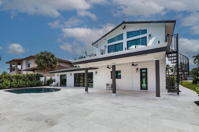 rear view of property with ceiling fan and a patio