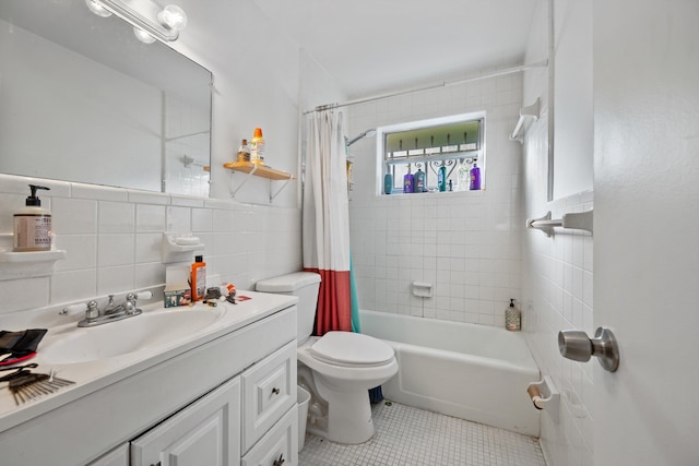 full bathroom featuring tile patterned floors, shower / tub combo with curtain, tile walls, and toilet