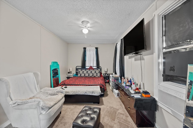 carpeted bedroom featuring a textured ceiling and ceiling fan