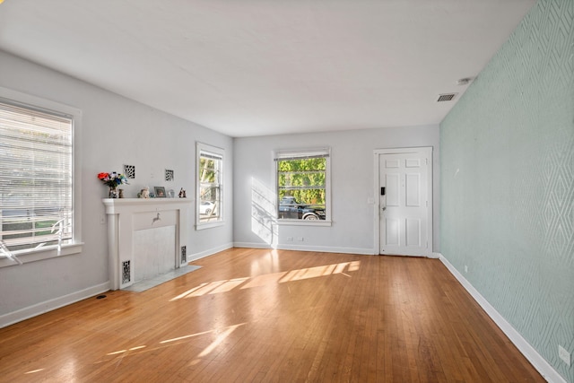 entryway with hardwood / wood-style floors and a fireplace