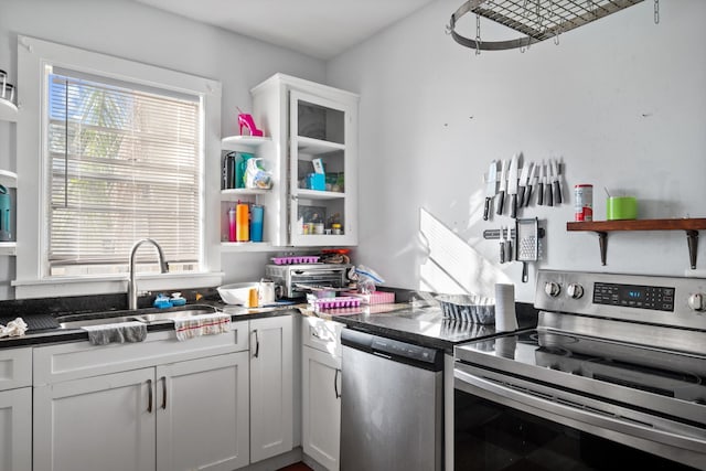 kitchen featuring white cabinetry, sink, and appliances with stainless steel finishes