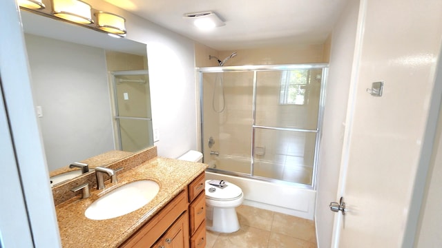 full bathroom featuring tile patterned flooring, vanity, toilet, and enclosed tub / shower combo