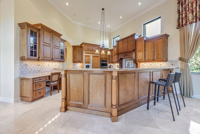 kitchen featuring stainless steel oven, a high ceiling, a kitchen breakfast bar, kitchen peninsula, and pendant lighting