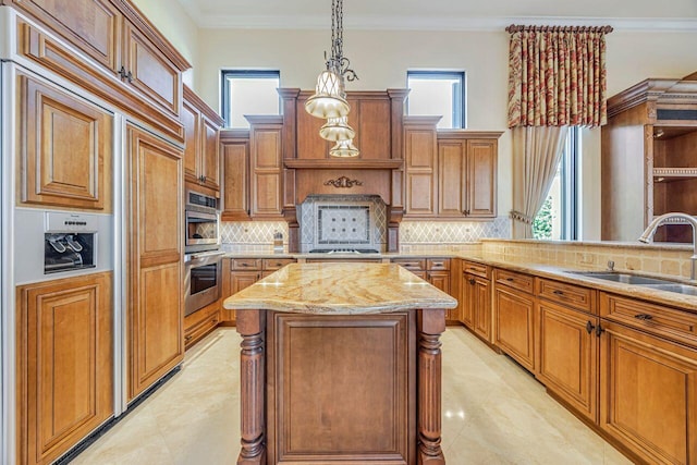 kitchen with backsplash, decorative light fixtures, a healthy amount of sunlight, and sink