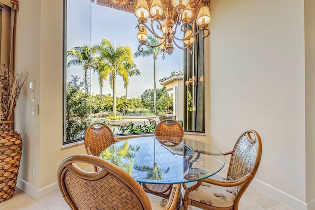 dining area with light tile patterned floors, an inviting chandelier, and a healthy amount of sunlight