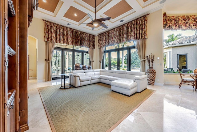 living room with crown molding, a wealth of natural light, and coffered ceiling