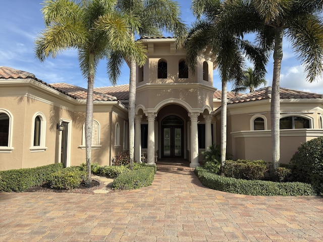 mediterranean / spanish-style home with french doors