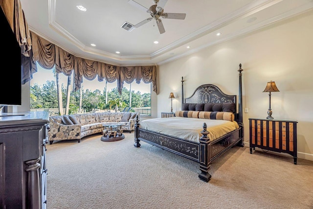 carpeted bedroom featuring ceiling fan, a raised ceiling, and ornamental molding