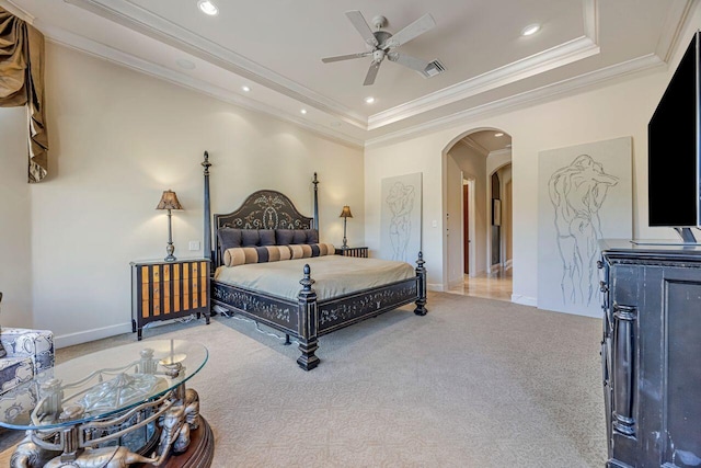 bedroom featuring ceiling fan, a raised ceiling, carpet floors, and crown molding