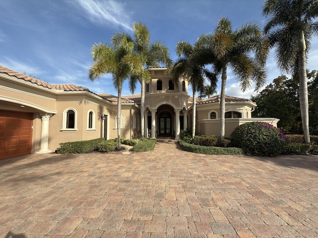 mediterranean / spanish-style home with a garage