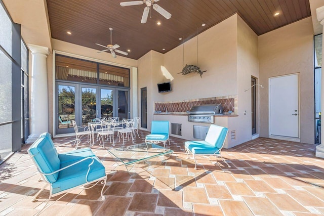 view of patio with ceiling fan and a grill