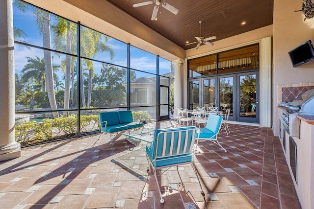 unfurnished sunroom featuring ceiling fan and wooden ceiling