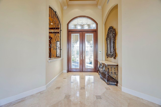 foyer with french doors and ornamental molding