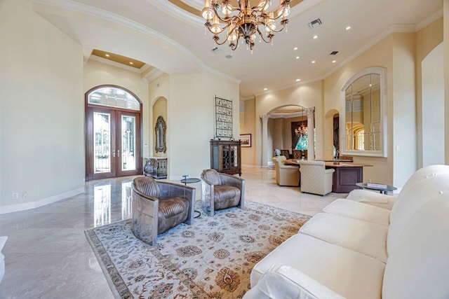 living room featuring french doors, a high ceiling, crown molding, and a notable chandelier