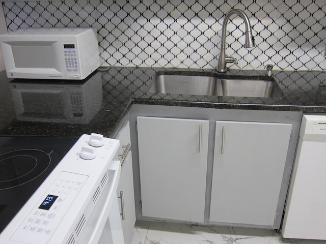 kitchen featuring white cabinets, white appliances, sink, and tasteful backsplash