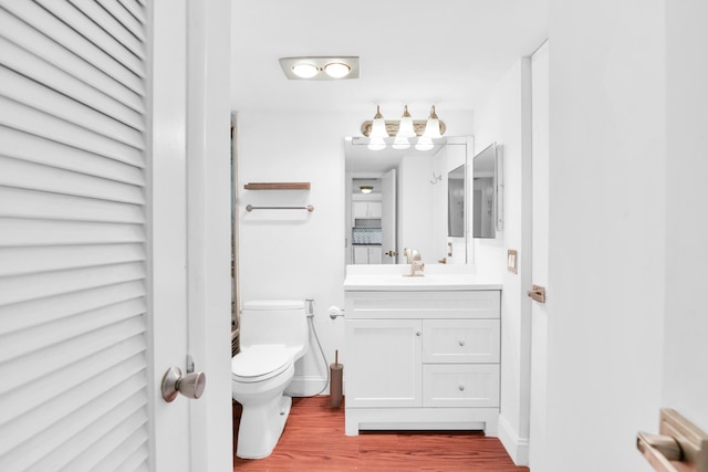 bathroom with vanity, hardwood / wood-style flooring, and toilet