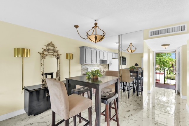 dining space featuring a textured ceiling