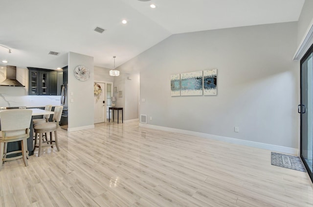 interior space with lofted ceiling and light wood-type flooring