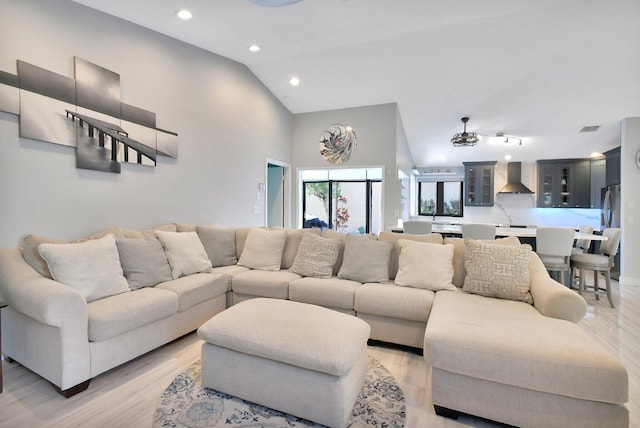 living room with light hardwood / wood-style flooring and lofted ceiling