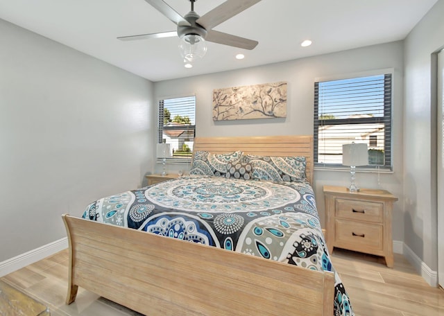 bedroom with ceiling fan and light hardwood / wood-style flooring