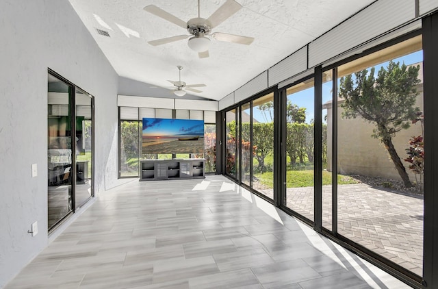 unfurnished sunroom featuring ceiling fan