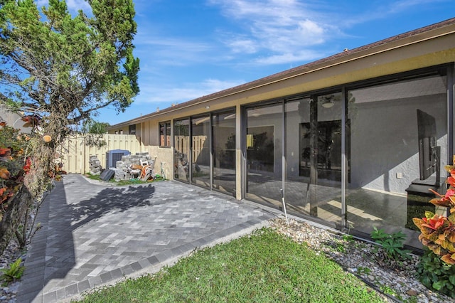 back of house featuring a sunroom and a patio