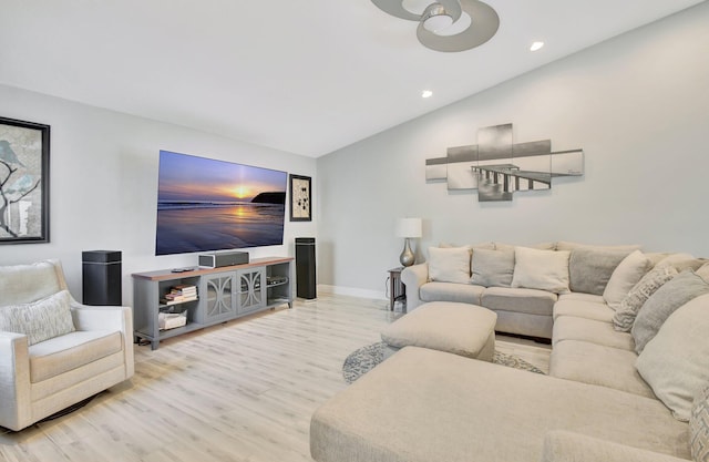 living room featuring light wood-type flooring and lofted ceiling