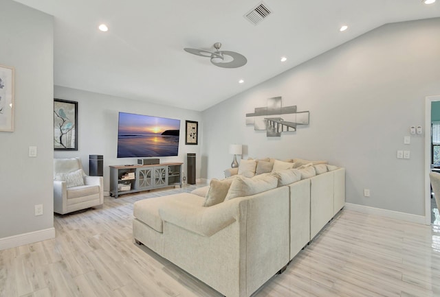 living room featuring light hardwood / wood-style floors, ceiling fan, and lofted ceiling