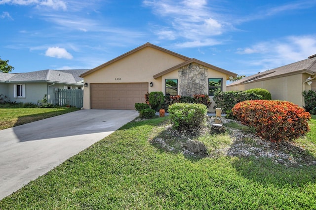 ranch-style home with a garage and a front lawn