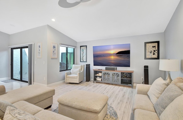 living room with light hardwood / wood-style flooring and lofted ceiling