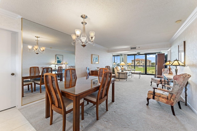 carpeted dining area featuring ceiling fan with notable chandelier, a textured ceiling, and ornamental molding