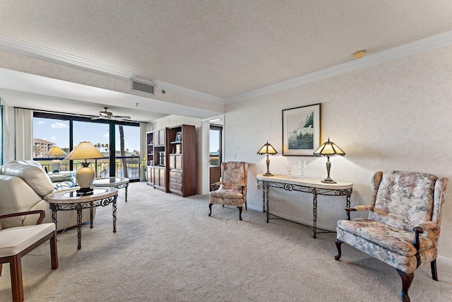 interior space with light colored carpet, a textured ceiling, and ornamental molding