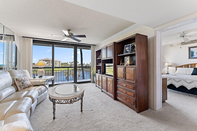 carpeted living room with crown molding, expansive windows, and a textured ceiling