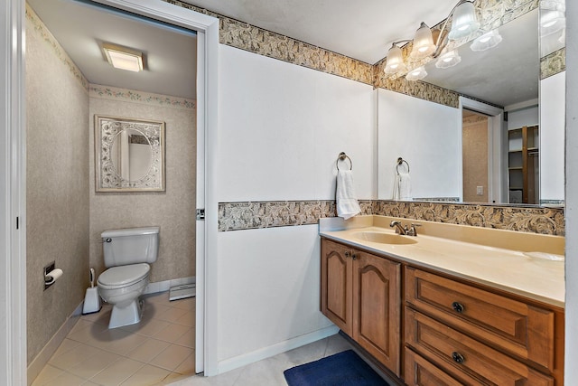 bathroom featuring tile patterned flooring, vanity, and toilet