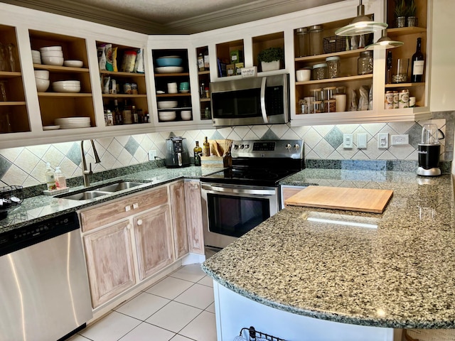 kitchen featuring backsplash, sink, ornamental molding, light tile patterned floors, and stainless steel appliances