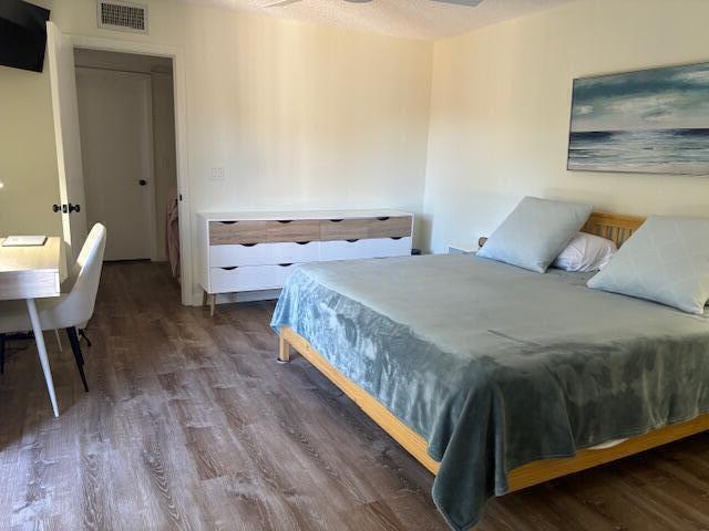 bedroom featuring ceiling fan and dark hardwood / wood-style flooring