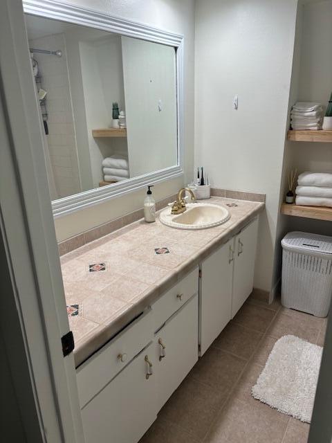 bathroom with tile patterned floors and vanity