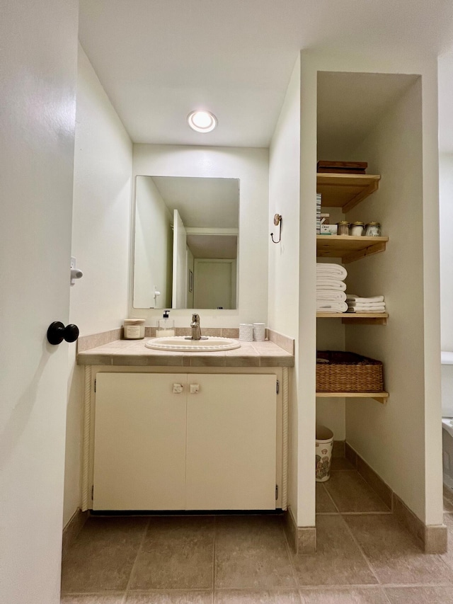 bathroom with tile patterned flooring and vanity