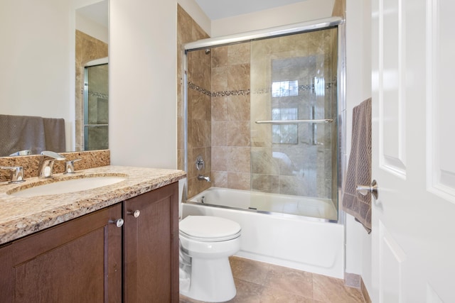 full bathroom featuring tile patterned flooring, toilet, combined bath / shower with glass door, and vanity